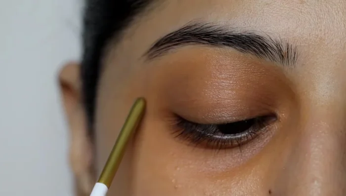 Blend the concealer outwards to avoid harsh lines.