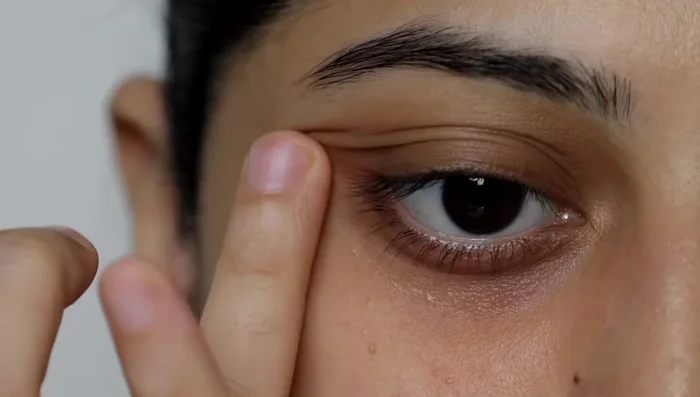 Gently massage the concealer into the skin using your ring finger in an upward direction.