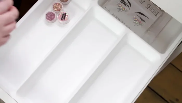 Store nail polishes, cuticle oil, nail hardener, false eyelash glue, and false eyelashes in a separate section of the drawer.