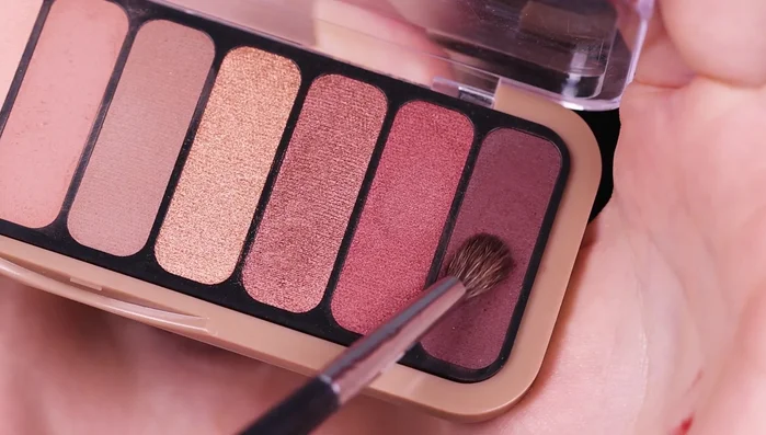 Deepen the crease further with matte black eyeshadow, using a tiny brush.