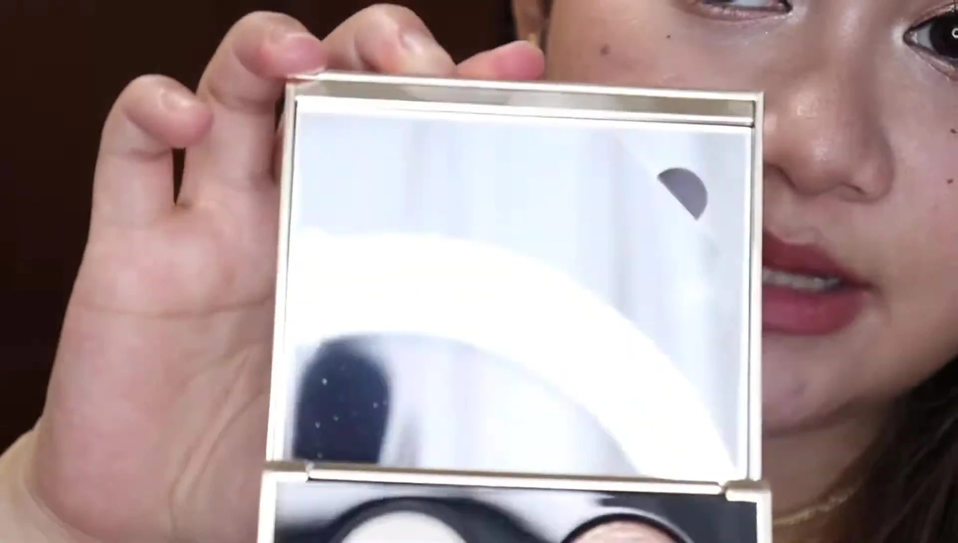 The palette opened, showcasing the mirror and eyeshadow shades.