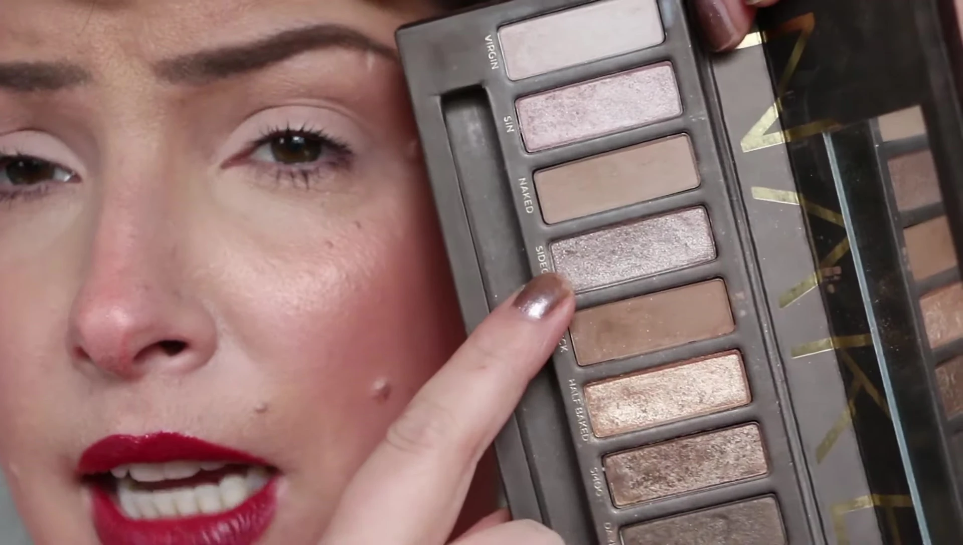 Applying eyeshadow from the Naked Palette