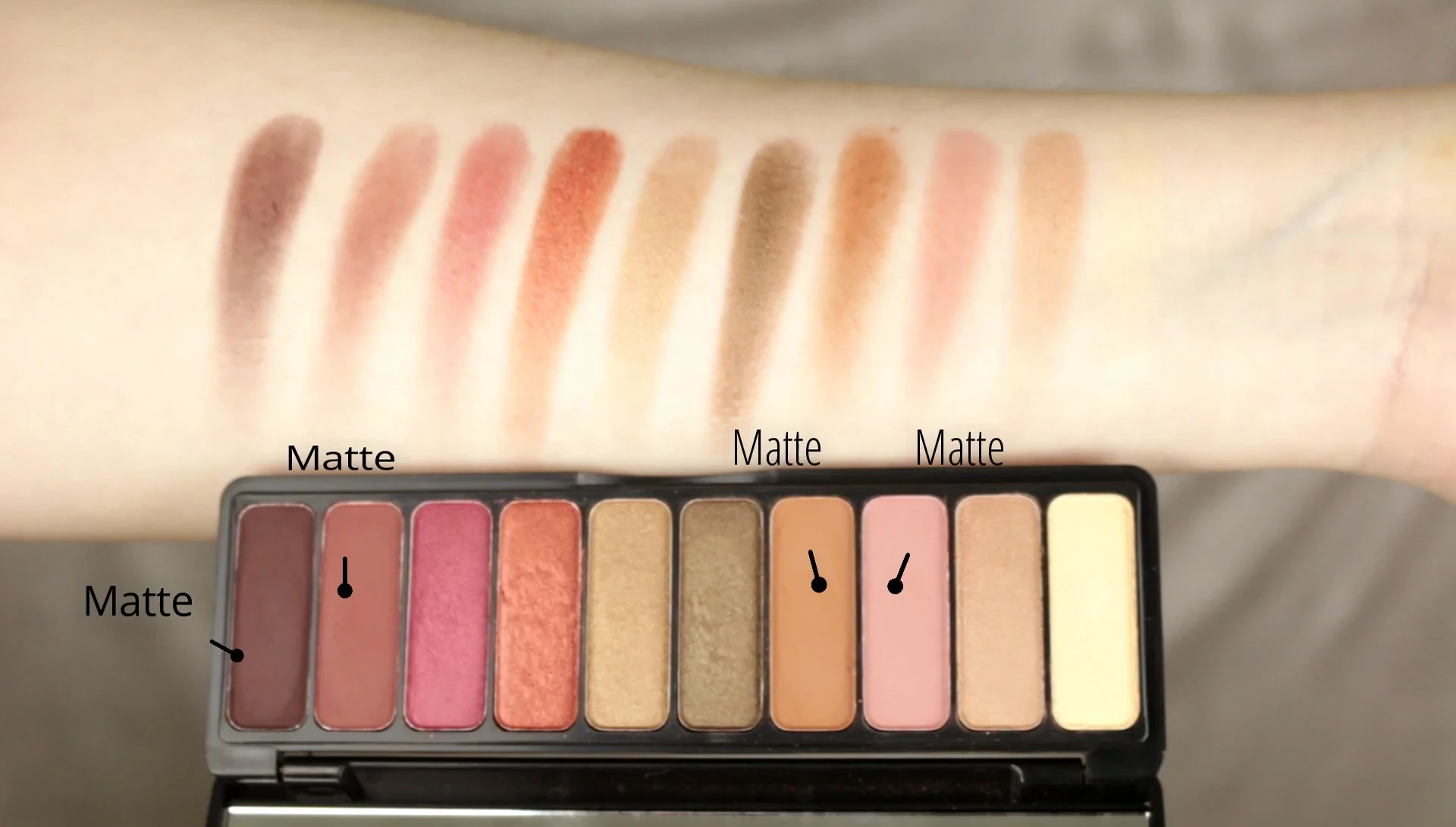 Close-up shot of eyeshadow swatches on the arm