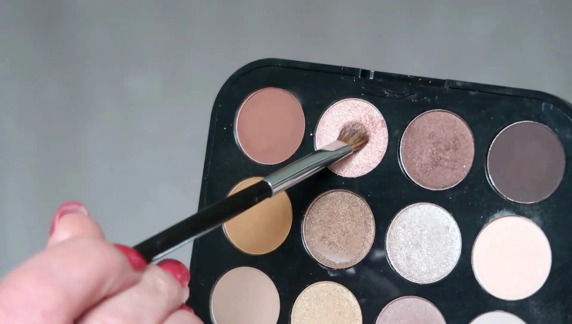 Applying the peachy-gold highlight shade.