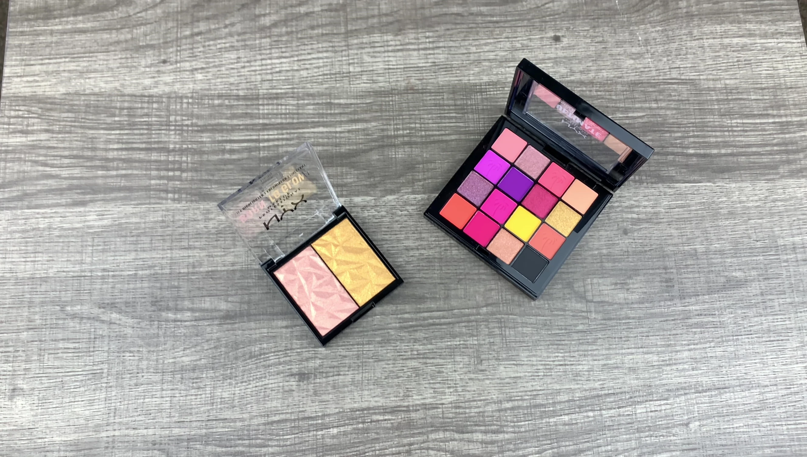 The reviewer's hand prepared for eyeshadow swatches.