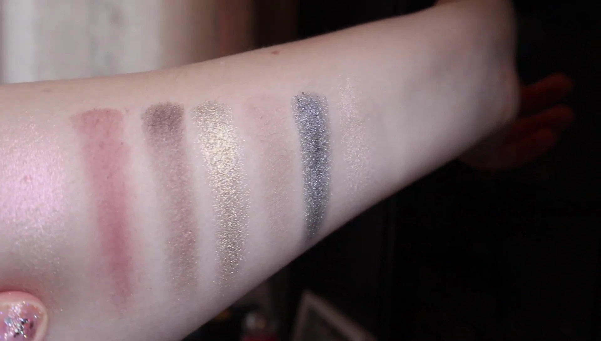 Swatches of the Smashbox x Hood By Air palette on the reviewer's arm.
