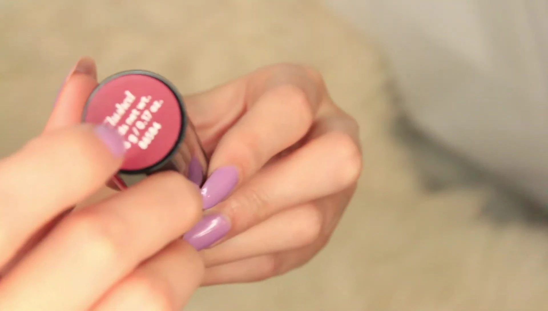 Close-up of the Buxom Power-Plump Tinted Lip Balm applicator and the lip balm itself.