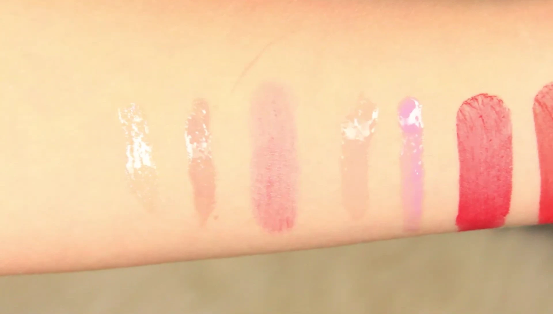 The reviewer shows the Buxom Plump Line Lip Liners packaging and pencils.