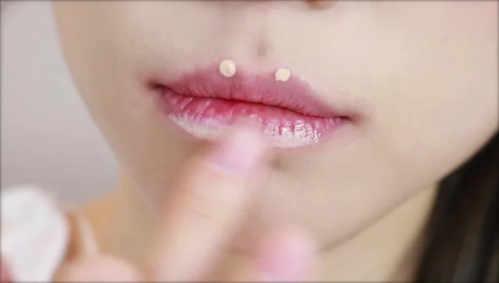 Optionally, apply concealer to your lips to create a smooth base and minimize lip lines.