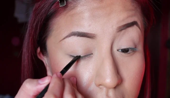 Apply a straight eyeliner look using the angled brush.