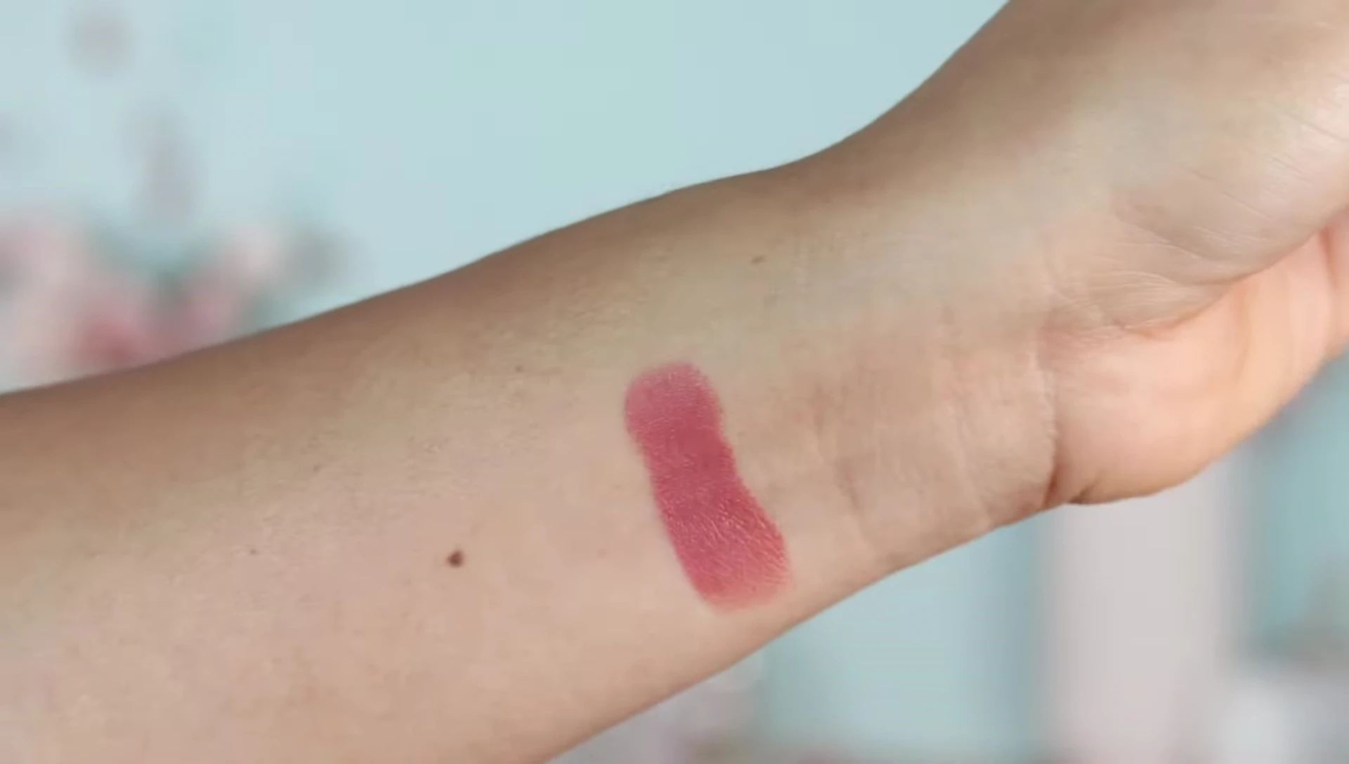 Smoked Almond lipstick swatch on the wrist.