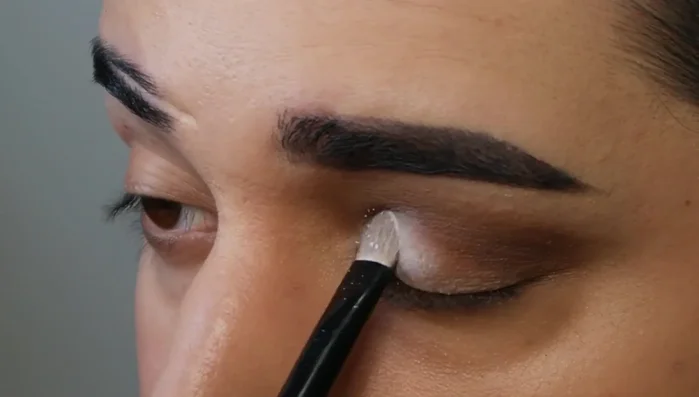 Gently blend out the lighter eyeshadow with a clean brush to avoid harsh lines.