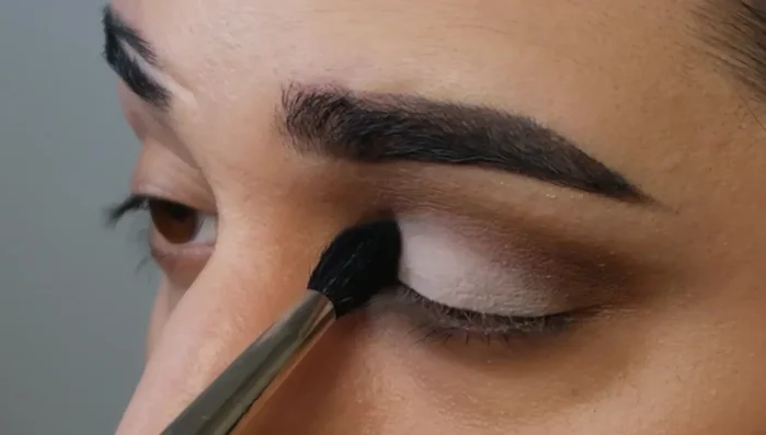 Gently blend out the lighter eyeshadow with a clean brush to avoid harsh lines.