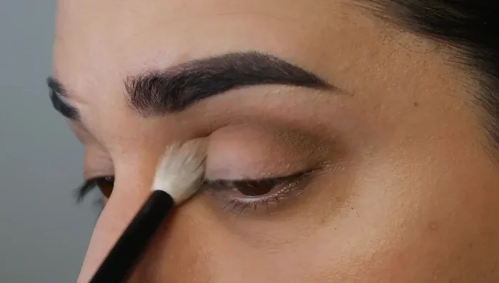 Buff out the eyeshadow using a bigger, fluffier brush in circular motions to create a wider, smoky effect.