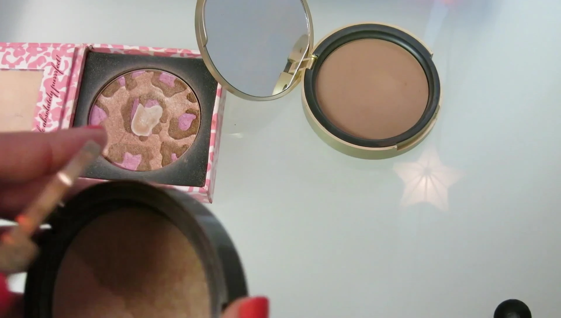 The reviewer displaying the Too Faced Sun Bunny bronzer.