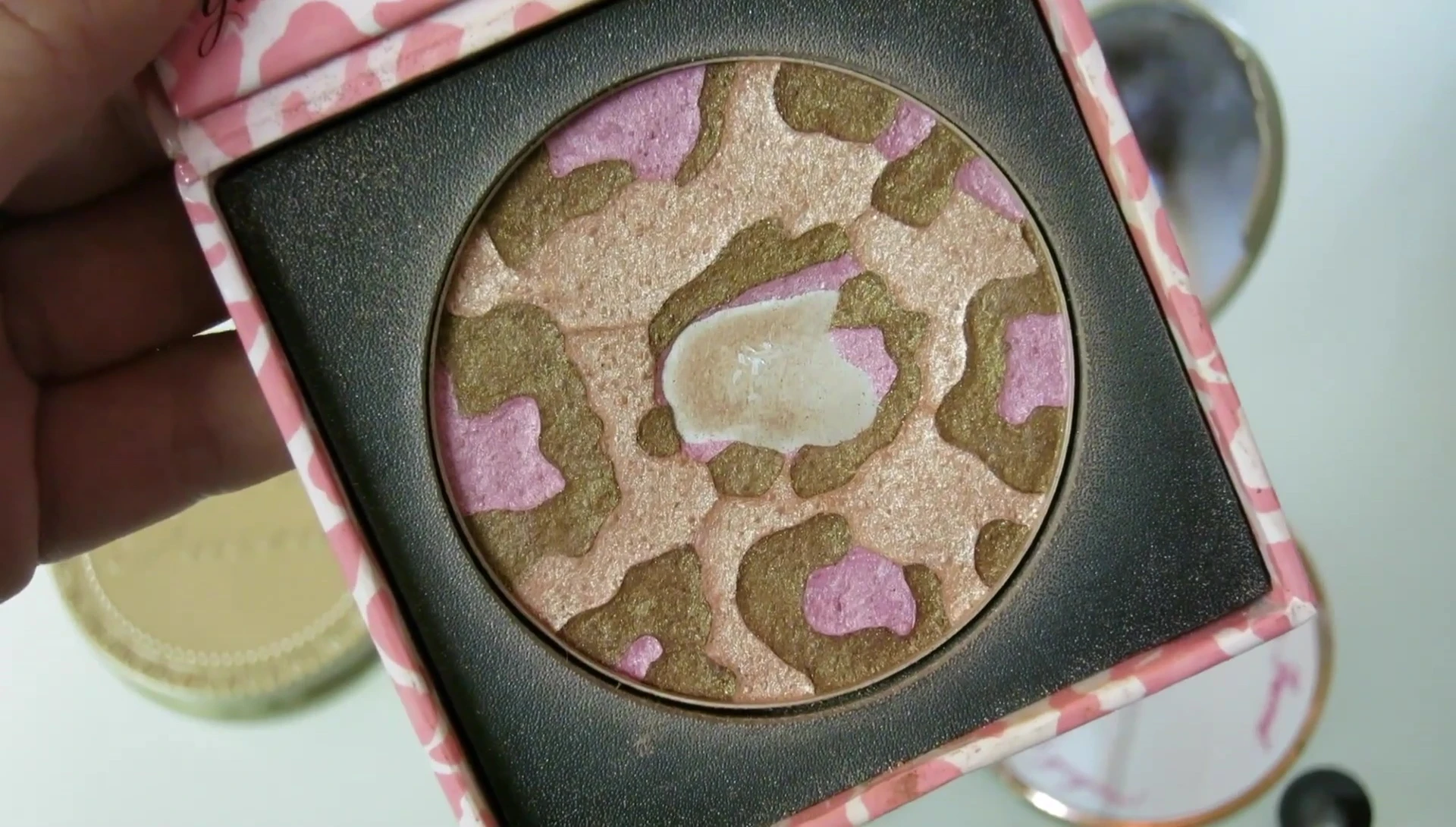 The reviewer demonstrating the bronzer's application and finish.