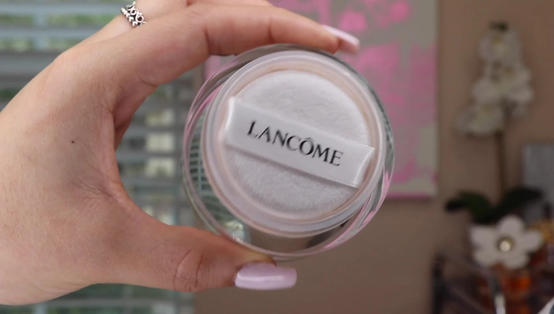 Powder container opened, showing the powder puff