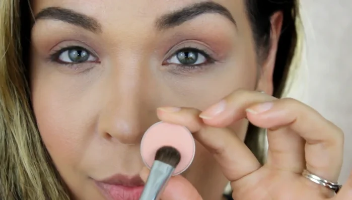 Apply “Peach Crisp” eyeshadow to the eyelid using the allover shader brush, patting and dabbing the color.