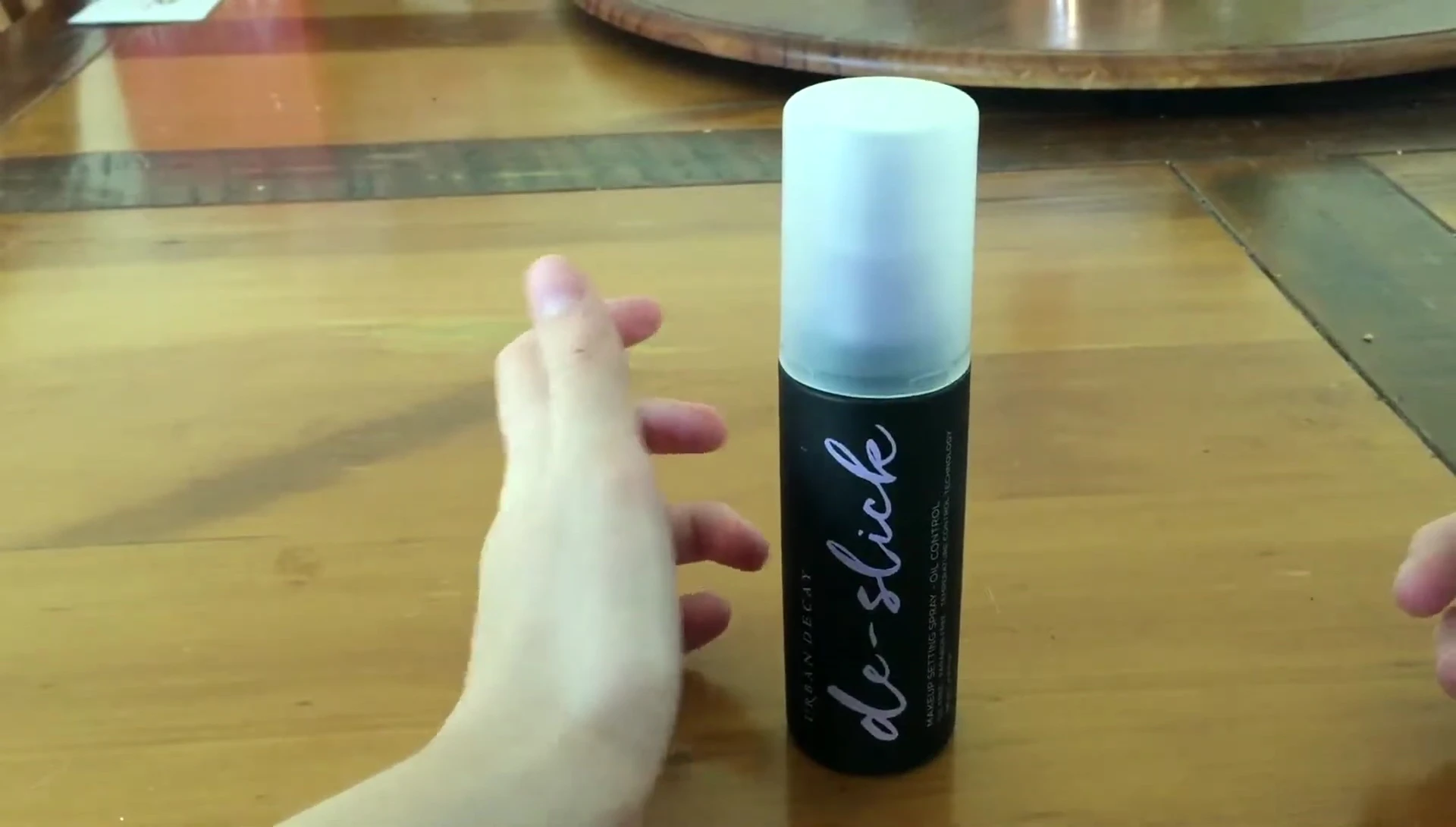 Speaker highlighting the long-lasting makeup after using the spray.