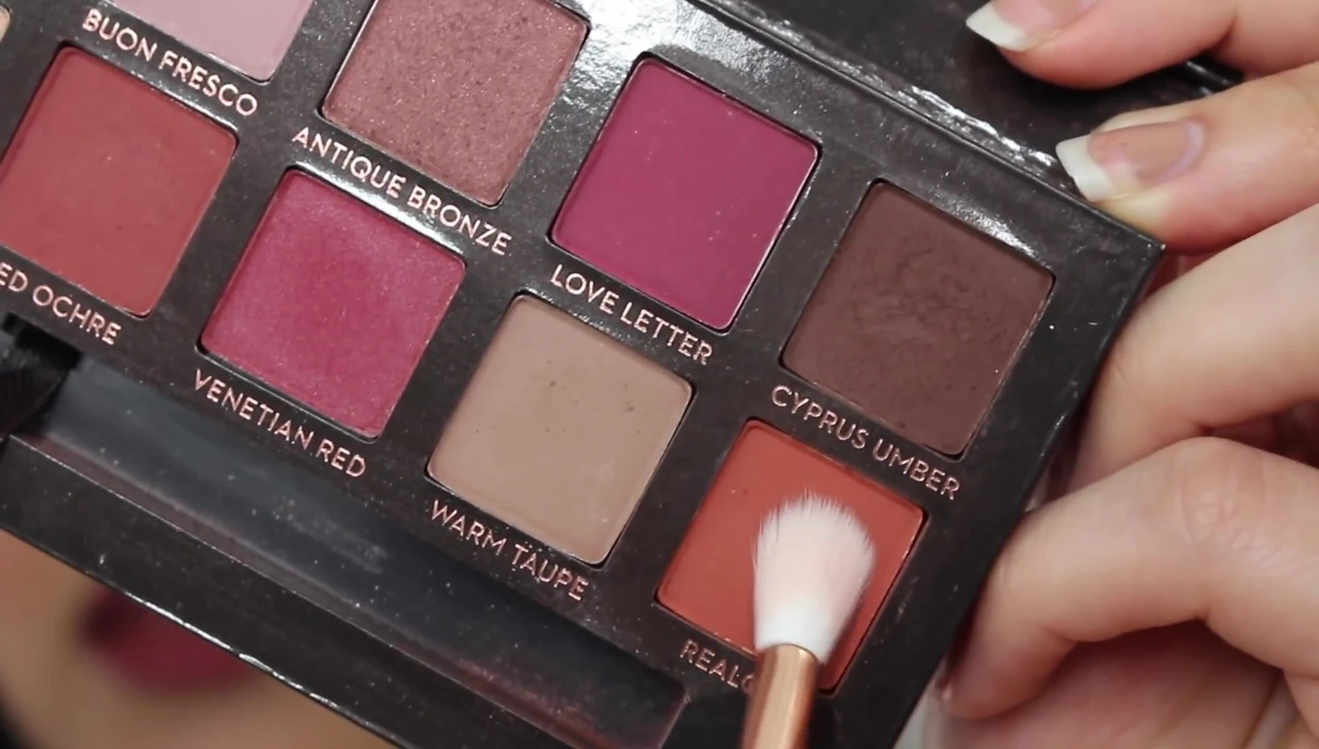 Applying eyeshadow with a smaller fluffy brush
