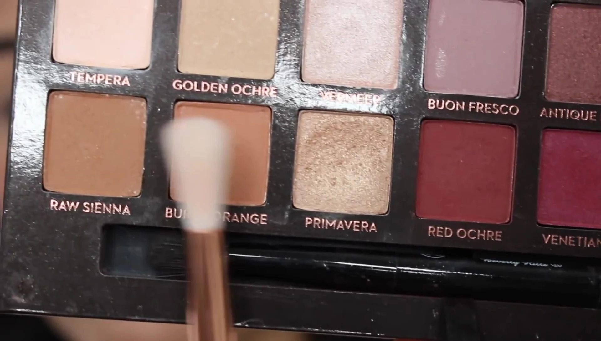 Using the large fluffy brush to apply eyeshadow