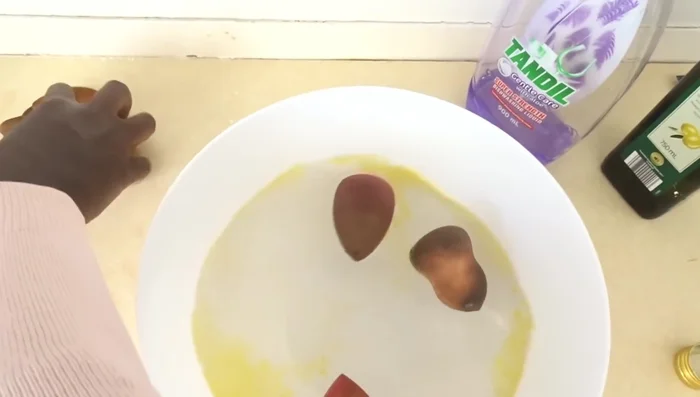 Let it soak: Allow the sponges to soak for about 3 minutes. The water will change color dramatically as the makeup dissolves.