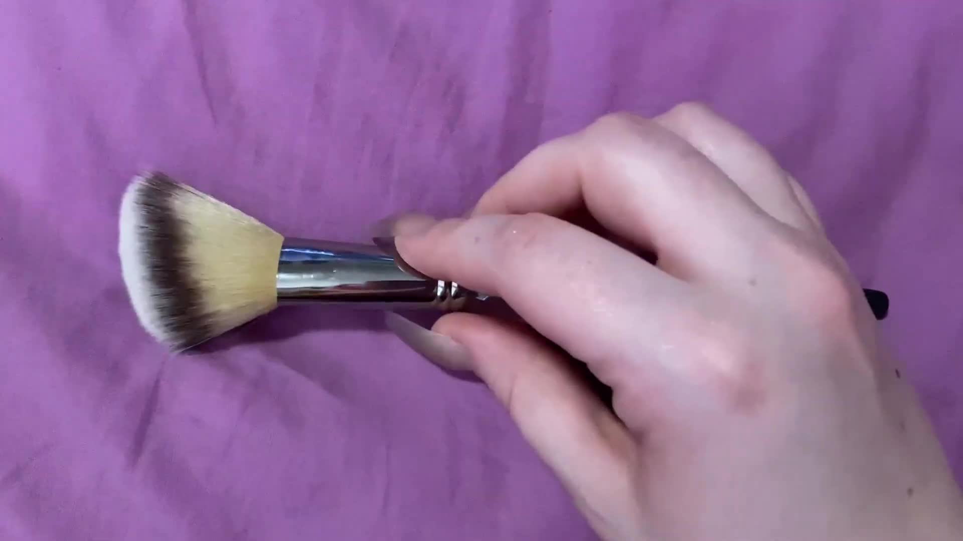 Close-up of the brush being held