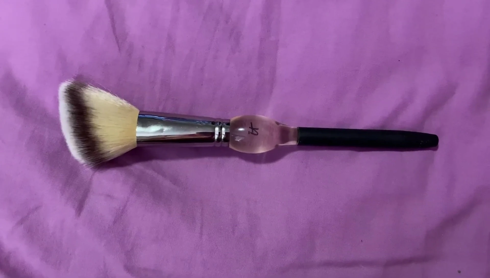 Brush applying powder over cream products