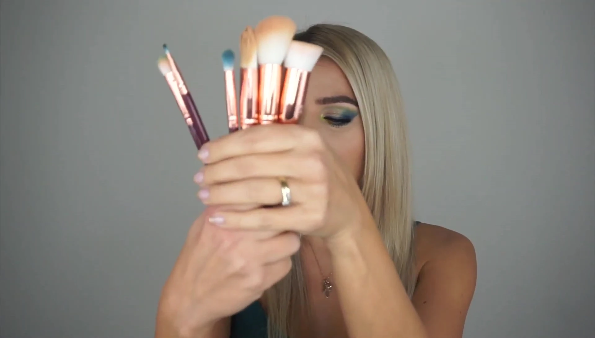 The reviewer holding the brush set, smiling.