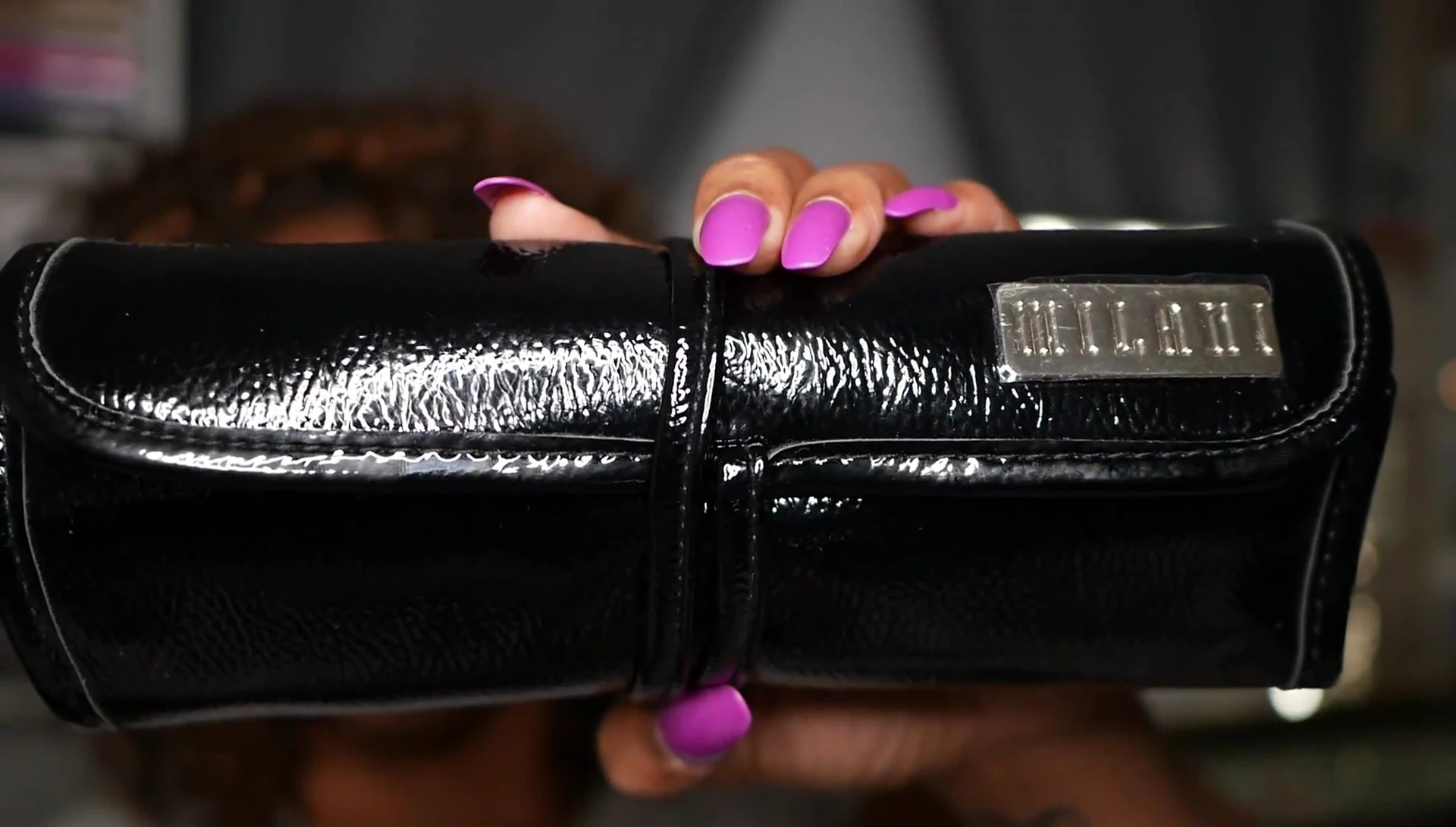 The Milani Luxe Holiday Brush Set in its black faux leather roll.
