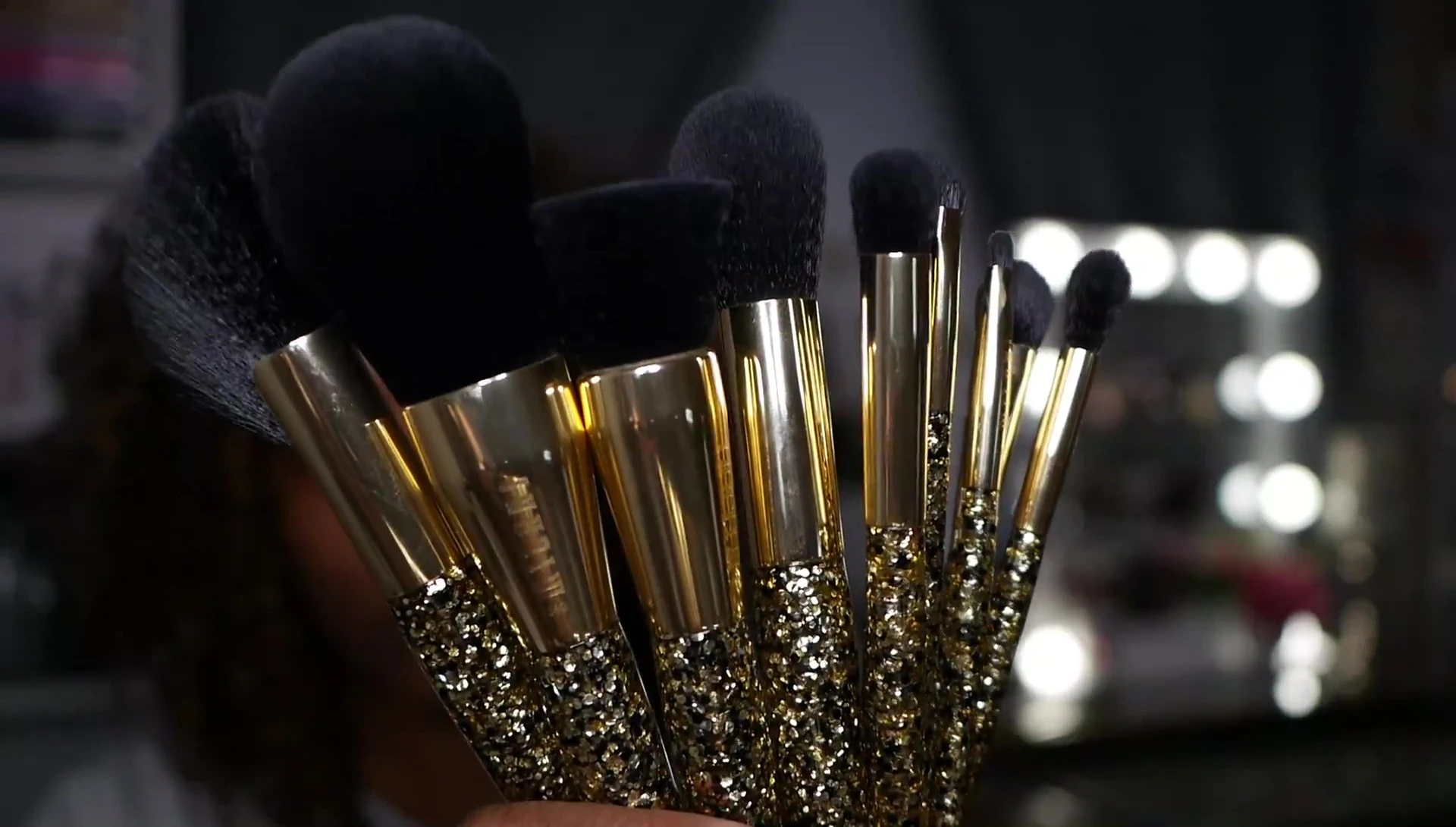 Close-up showcasing the golden-black ferrule and handle design of one of the brushes.