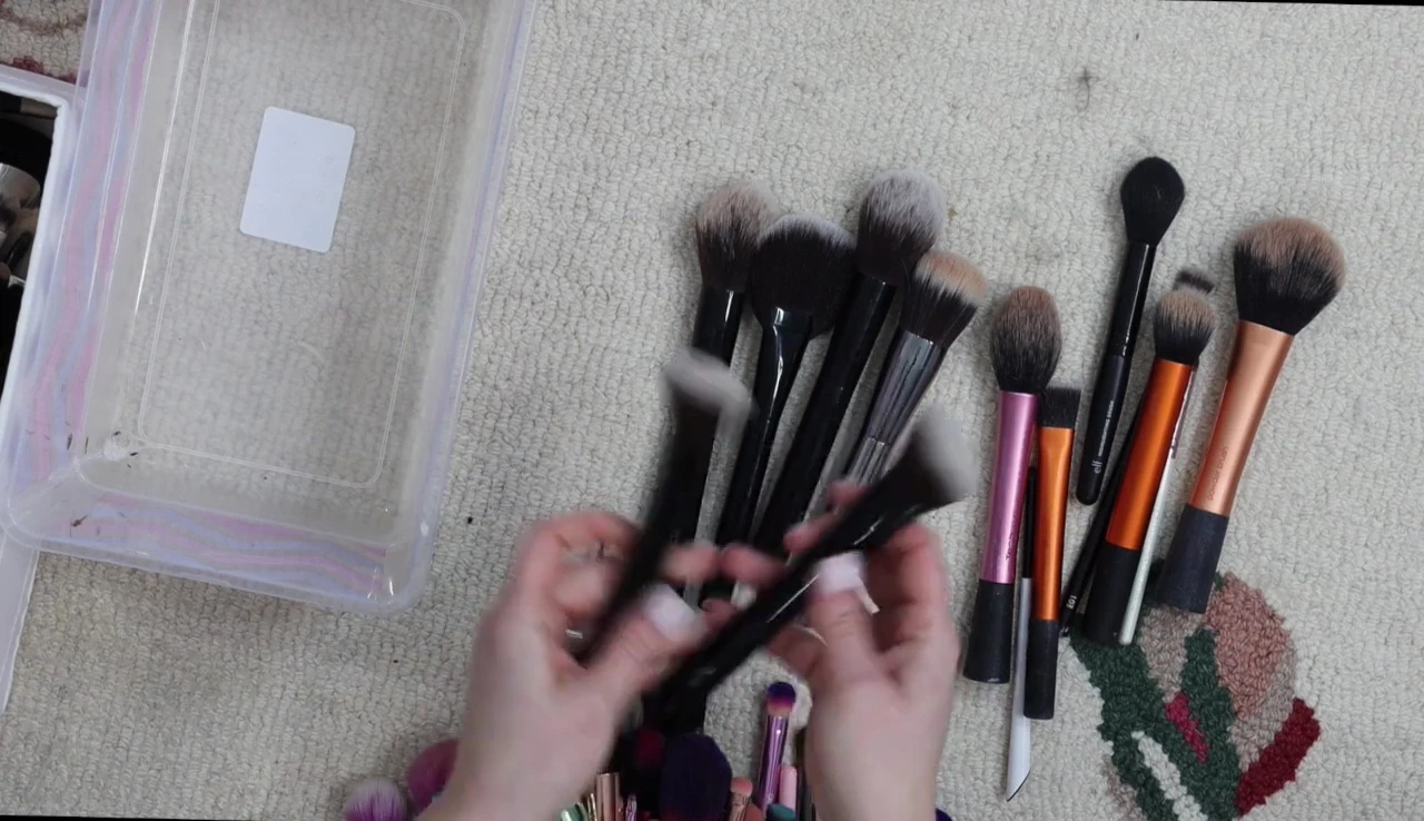 The speaker is holding up two Julep blush brushes, which she decided to keep.