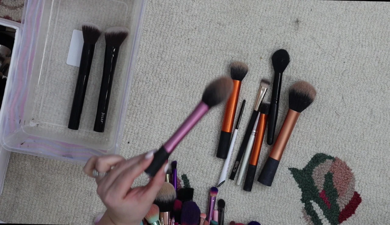 The speaker is holding a Real Techniques brush, highlighting its value.