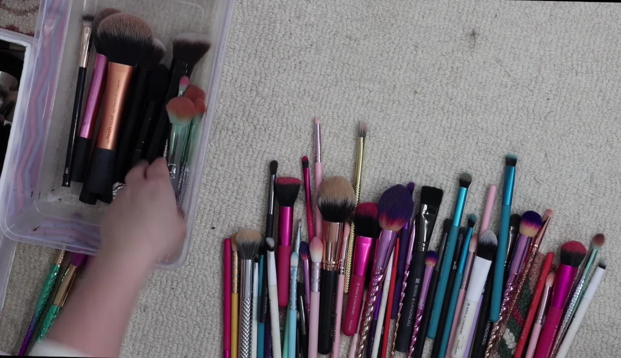 The speaker shows a small set of travel-sized brushes she is keeping.