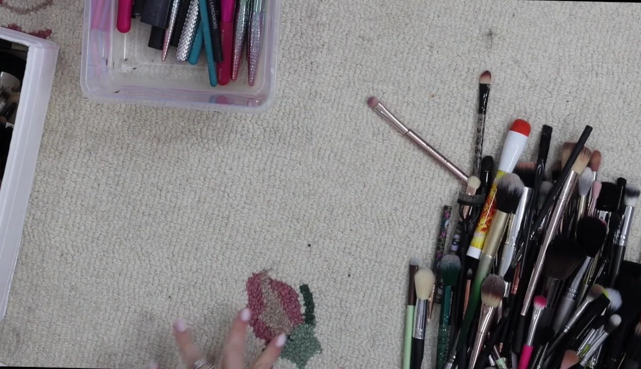 The speaker begins to sort through the random pile, separating keeping and discarding brushes.