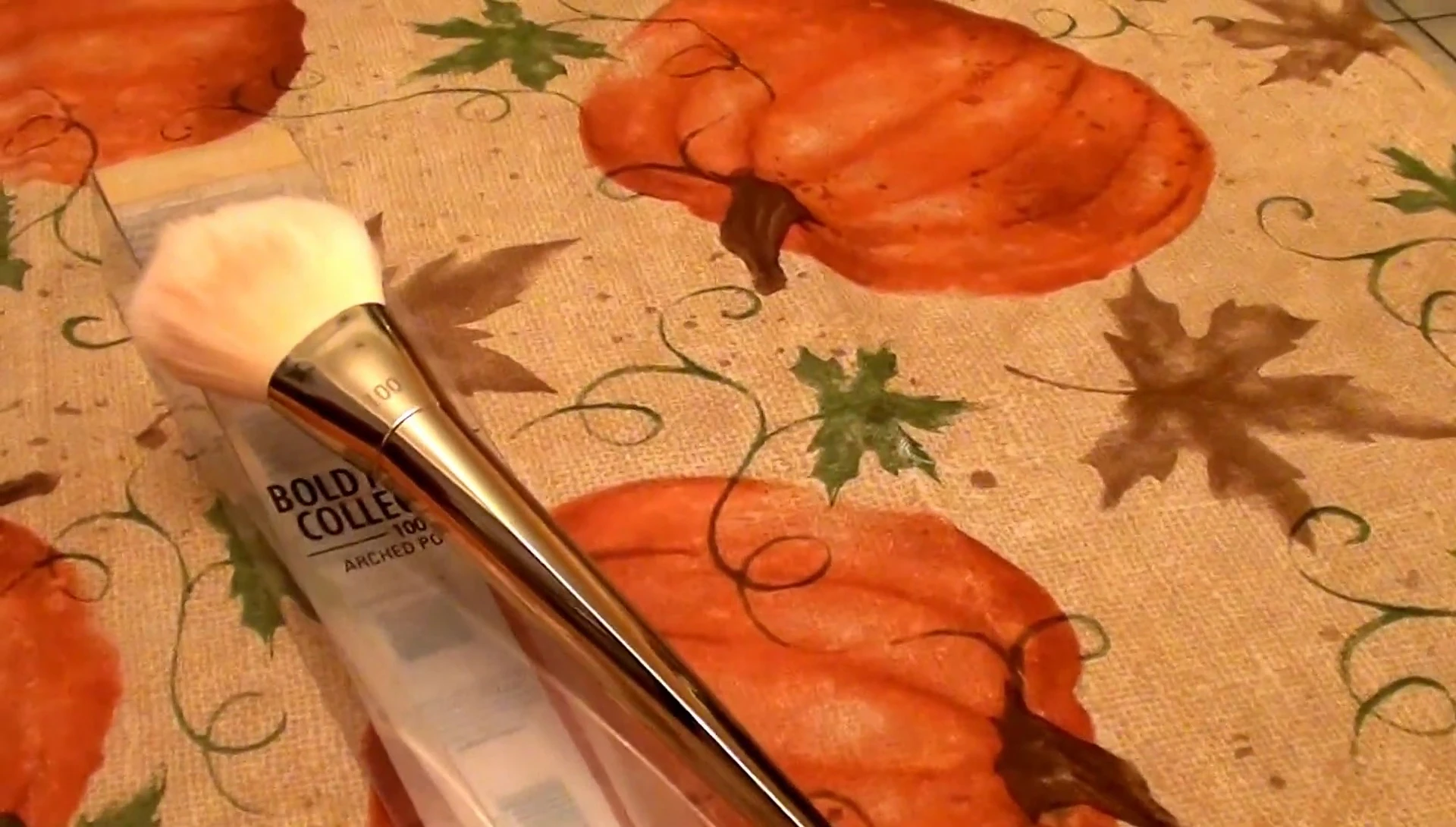 The reviewer demonstrating the brush's application with pressed powder.
