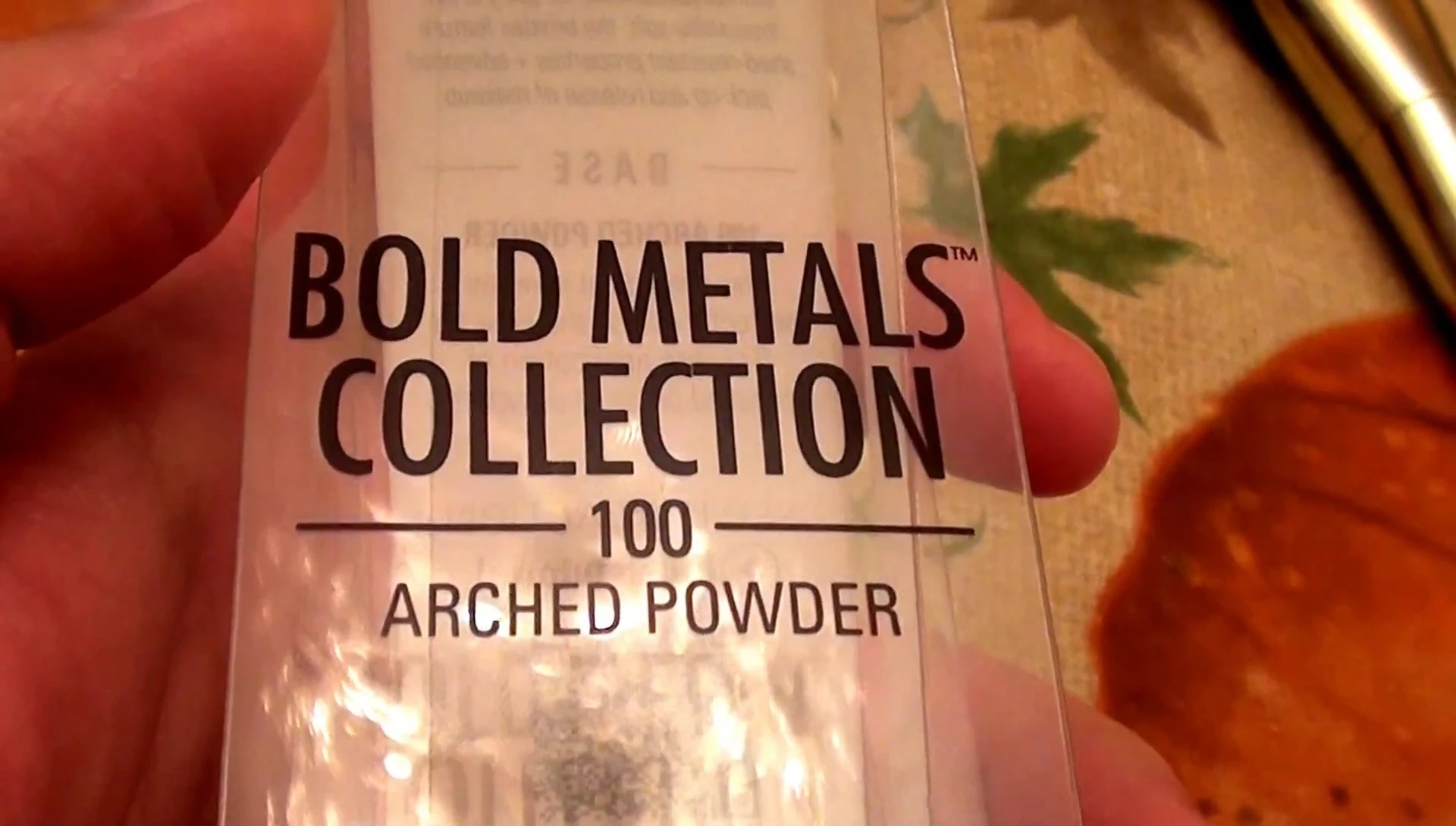 Close-up of the Real Techniques Bold Metals 100 Arched Powder Brush packaging.
