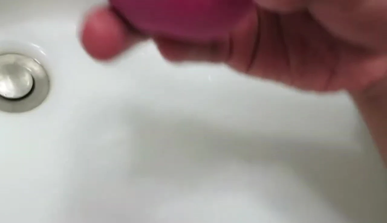 The sponge being cleaned with the solid soap.