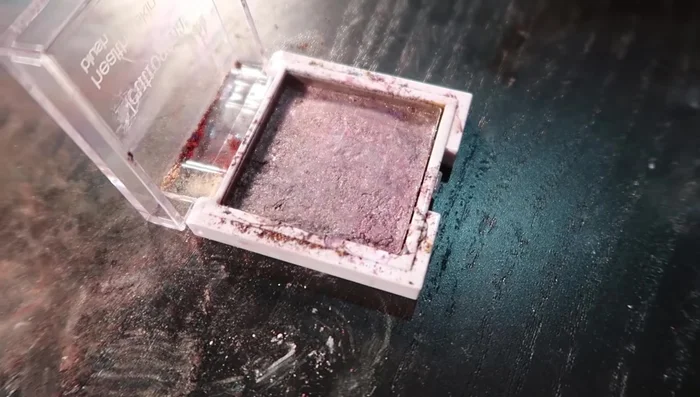 Flatten the dried eyeshadow using a stamper or similar tool.