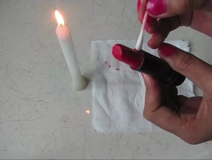 Use a Q-tip or lipstick brush to clean up any excess lipstick around the edges.