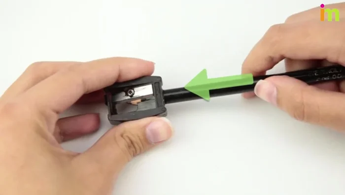 Sharpen the eyeliner by turning the pencil in the sharpener.