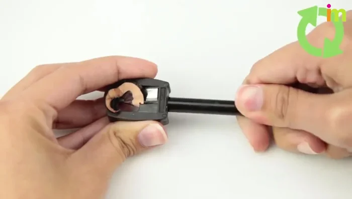 Sharpen the eyeliner by turning the pencil in the sharpener.