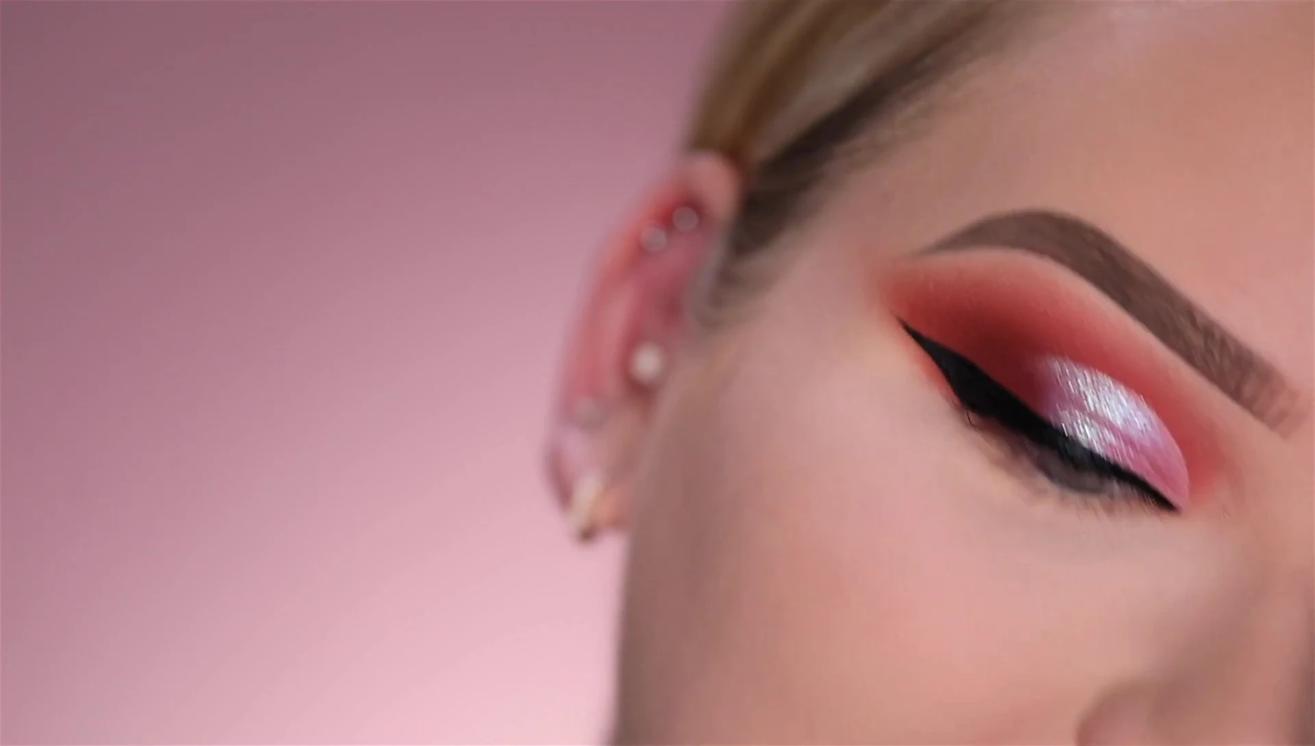 Applying the dark brown shade to the lower lash line.