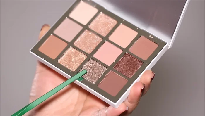 Apply a shimmer eyeshadow using your finger, starting from the inner corner and tapering off towards the outer corner to cover harsh edges and create a seamless blend.