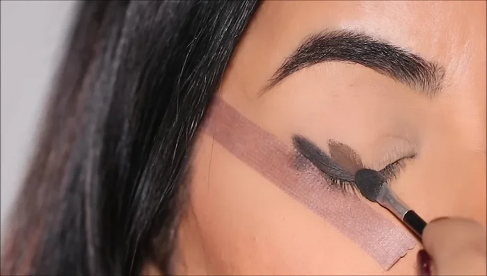 Apply a deeper brown shade next to the charcoal, followed by a lighter brown shade beside that.