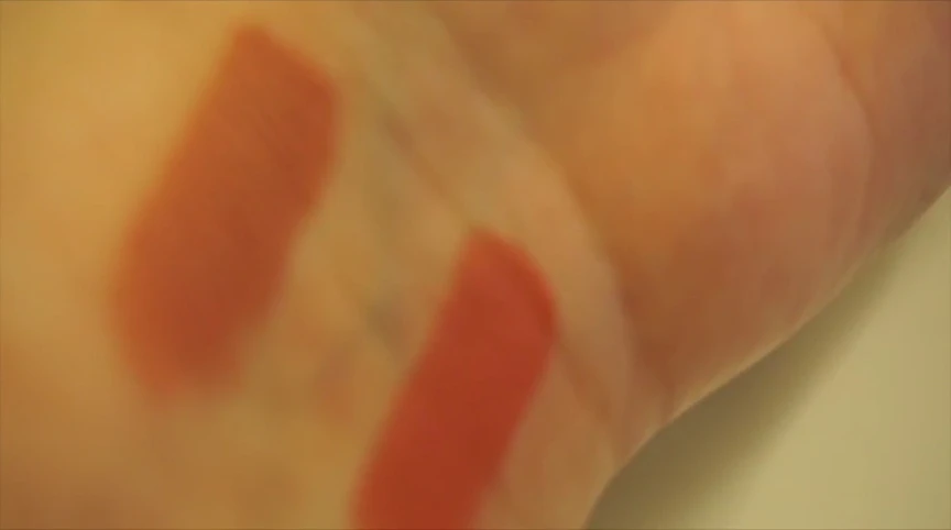 Model showing the lipstick applied on her lips.