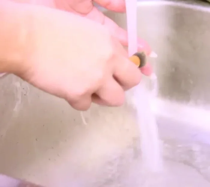 Continue rinsing and swirling until all soap and makeup residue are gone. The water should run clear.