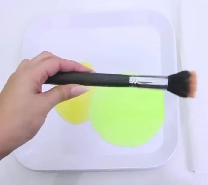 Swirl the brush in the palm of your hand to distribute the mixture and clean the bristles.