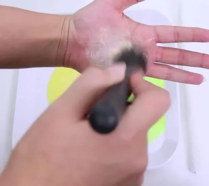 Swirl the brush in the palm of your hand to distribute the mixture and clean the bristles.