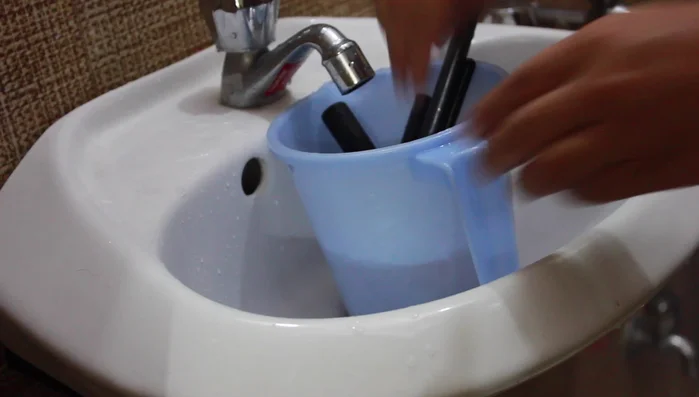 Give brushes a final rinse in a mug of clean water.